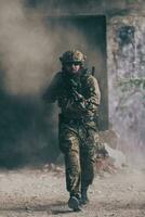 A bearded soldier in uniform of special forces in a dangerous military action in a dangerous enemy area. Selective focus photo