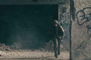 A bearded soldier in uniform of special forces in a dangerous military action in a dangerous enemy area. Selective focus photo