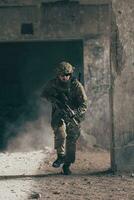 A bearded soldier in uniform of special forces in a dangerous military action in a dangerous enemy area. Selective focus photo