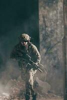 A bearded soldier in uniform of special forces in a dangerous military action in a dangerous enemy area. Selective focus photo