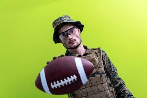 solder holding american football ball photo