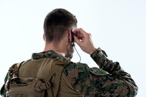 soldier preparing gear for action and checking communication photo