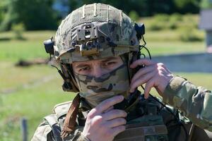 special operations soldiers team preparing tactical and communication gear for action battle. Long distance sniper team in checking gear for action photo