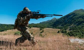 Sniper soldier assisted by an assistant to observe the area to be targeted with modern warfare tactical virtual reality goggles aerial drone military technology. photo