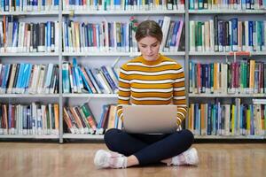 the student uses a notebook and a school library photo