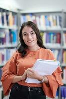 the student uses a notebook and a school library photo