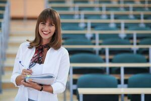 famale student using pen and notebook photo