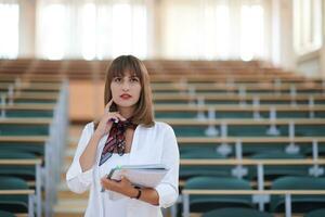 famale student using pen and notebook photo