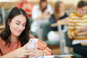 famel students using smartphone in classroom photo