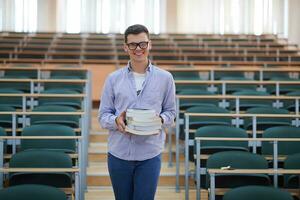 man with book in calssroom photo