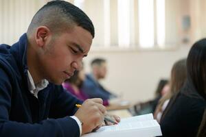 student taking notes while studying in high school photo