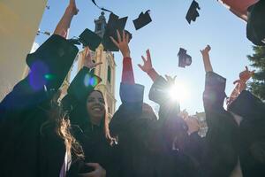 Group of diverse international graduating students celebrating photo