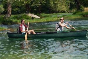 couple of explorers conoining on wild river photo