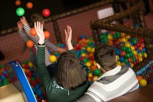 young parents with kids in a children's playroom photo