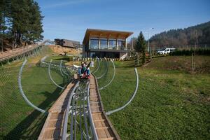 couple enjoys driving on alpine coaster photo