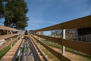 mother and son enjoys driving on alpine coaster photo