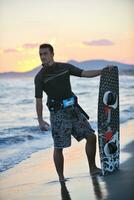 retrato, de, un, joven, kitsurf, hombre, en, playa, en, ocaso foto