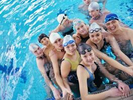 happy teen group  at swimming pool photo