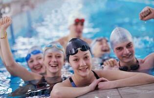 happy teen group  at swimming pool photo