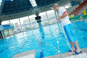 help and rescue on swimming pool photo