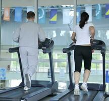 people running on threadmill at fitness club photo