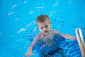 child on swimming poo photo