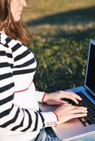 young teen girl work on laptop outdoor photo