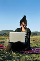 young teen girl work on laptop outdoor photo