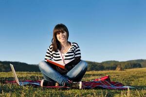 young teen girl work on laptop outdoor photo