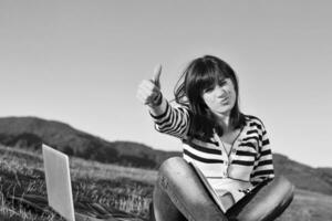 young teen girl work on laptop outdoor photo