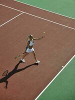 young woman play tennis outdoor photo