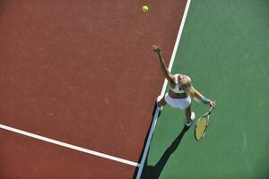 mujer joven jugar al tenis al aire libre foto