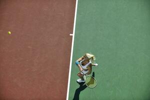 young woman play tennis outdoor photo