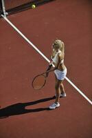 young woman play tennis outdoor photo