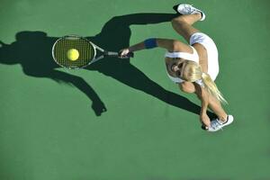 young woman play tennis outdoor photo