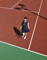 young woman play tennis game outdoor photo