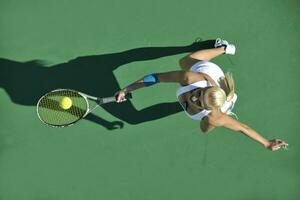 young woman play tennis outdoor photo