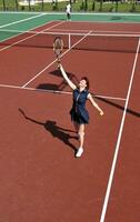 mujer joven jugar juego de tenis al aire libre foto