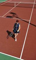 young woman play tennis game outdoor photo