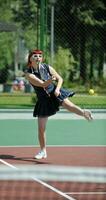 young woman play tennis game outdoor photo