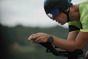 triathlon athlete riding a bike on morning training photo