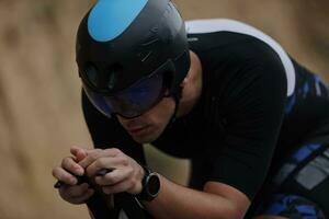 triathlon athlete riding a bike wearing black photo