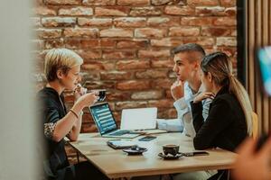 contento gente de negocios sonriente alegremente durante un reunión en un café tienda. grupo de exitoso negocio profesionales trabajando como un equipo en un multicultural lugar de trabajo. foto