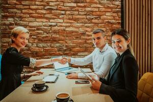 Business shaking hands, finishing up meeting. Successful businesspeople handshaking after good deal. photo