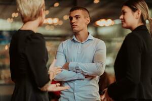 Photo of a business team of young people discussing business ideas in a modern urban environment. Selective focus