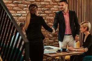 Business shaking hands, finishing up meeting. Successful businesspeople handshaking after good deal. photo