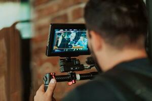 Cameraman working on professional camera taking stock footage photo