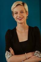 Pretty business woman, successful confidence with arms crossed on modern blue mat background. Selective focus photo