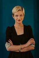 Pretty business woman, successful confidence with arms crossed on modern blue mat background. Selective focus photo