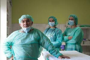 Portrait of doctors wearing uniform and preparing to doing surgical operation at the theater of hospital. Medical Concept. photo